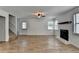 Open living room with a fireplace, wood floors, stairs and ample natural light at 4278 Trotters Ln, Auburn, GA 30011
