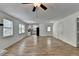 Bright open concept living room with wood floors, a fireplace, and access to kitchen at 4278 Trotters Ln, Auburn, GA 30011