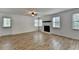 Bright living room features a fireplace, wood floors, and natural light from multiple windows at 4278 Trotters Ln, Auburn, GA 30011