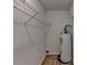 Storage room featuring wood flooring, shelves, and a water heater at 4278 Trotters Ln, Auburn, GA 30011