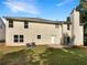 Back exterior of home with chimney and small patio, showcasing vinyl siding and a manicured lawn at 6260 Selborn Sw Dr, Atlanta, GA 30331