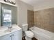 Well-lit bathroom with a combination shower and tub, tiled shower walls, and a single sink vanity at 6260 Selborn Sw Dr, Atlanta, GA 30331