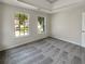 Bedroom featuring tray ceiling, large windows and plush carpeting at 6260 Selborn Sw Dr, Atlanta, GA 30331