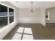 Bright dining room with chandelier, wainscoting, and large windows at 6260 Selborn Sw Dr, Atlanta, GA 30331