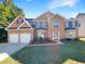 Charming two-story brick home with a well-manicured lawn and a two-car garage at 6260 Selborn Sw Dr, Atlanta, GA 30331