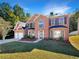 Beautiful two-story brick home with manicured lawn, two-car garage, and mature landscaping at 6260 Selborn Sw Dr, Atlanta, GA 30331