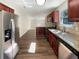 Well-lit kitchen boasts stainless appliances, granite counters, and dark wood cabinets with an open floor plan at 6260 Selborn Sw Dr, Atlanta, GA 30331