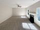 Spacious living room with fireplace, fan, and neutral carpet at 6260 Selborn Sw Dr, Atlanta, GA 30331