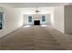 Spacious living room with neutral carpet, fireplace, and large windows for natural light at 6260 Selborn Sw Dr, Atlanta, GA 30331