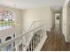 Elegant staircase with wooden steps, a large arched window, and an attractive chandelier at 6260 Selborn Sw Dr, Atlanta, GA 30331