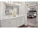 Elegant Primary bathroom with dual vanities, white cabinetry, and a glass-enclosed shower with view to main bedroom at 6427 Rosetta Dr # 64, South Fulton, GA 30331