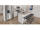 Bright kitchen featuring white cabinets, stainless steel appliances, and an island with barstool seating at 6427 Rosetta Dr # 64, South Fulton, GA 30331