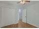Cozy bedroom featuring a ceiling fan, a spacious closet, and hardwood flooring at 6964 Oakhill Cir, Austell, GA 30168