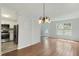 Bright dining room features hardwood floors and a modern chandelier at 6964 Oakhill Cir, Austell, GA 30168