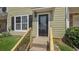 Close-up of the front entrance with a decorative glass door, stairs, and manicured lawn at 6964 Oakhill Cir, Austell, GA 30168