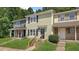 Charming townhome with light green siding, black shutters, and stairs leading up to a covered entryway at 6964 Oakhill Cir, Austell, GA 30168