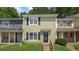 Charming two-story townhome with light green siding, black shutters, and a inviting front entrance at 6964 Oakhill Cir, Austell, GA 30168