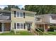 Charming two-story townhome with light green siding, black shutters, and well-maintained front lawn at 6964 Oakhill Cir, Austell, GA 30168