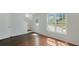 Bright living room with white walls, hardwood floors, and a large window providing natural light at 6964 Oakhill Cir, Austell, GA 30168