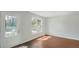 Bright living room with white walls, hardwood floors, and a decorative front door at 6964 Oakhill Cir, Austell, GA 30168