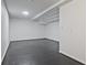 Finished basement with dark floors and white walls is ready to be customized at 783 Lost Creek Cir, Stone Mountain, GA 30088