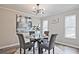 Elegant dining area featuring a glass table, stylish chairs, and modern lighting fixture at 783 Lost Creek Cir, Stone Mountain, GA 30088