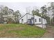 Charming renovated two-story home with a modern color scheme, landscaped yard, and inviting blue front door at 783 Lost Creek Cir, Stone Mountain, GA 30088