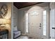 Inviting front foyer with a white front door, sidelights, a decorative sunburst mirror, and a charming bench at 783 Lost Creek Cir, Stone Mountain, GA 30088