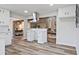 Modern kitchen with white cabinetry, stainless steel appliances, stylish backsplash, and a seamless flow to the living area at 783 Lost Creek Cir, Stone Mountain, GA 30088