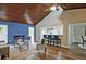 Open-concept living area showcasing a wood ceiling, electric fireplace, and seamless flow into the kitchen at 783 Lost Creek Cir, Stone Mountain, GA 30088