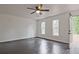 An airy living room featuring hardwood floors, ceiling fan, and natural light from two windows at 783 Lost Creek Cir, Stone Mountain, GA 30088