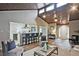 Bright, open-concept living room with vaulted ceilings, a fan, and hardwood floors at 783 Lost Creek Cir, Stone Mountain, GA 30088