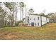 View of the rear of the home with its exterior, yard, and deck overlooking the serene surroundings at 783 Lost Creek Cir, Stone Mountain, GA 30088