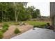 Spacious backyard featuring a brick patio, fire pit, and lush landscaping, perfect for outdoor entertaining at 1520 Great Oaks Dr, Lawrenceville, GA 30045