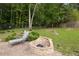 Landscaped backyard featuring a fire pit and lounge chair at 1520 Great Oaks Dr, Lawrenceville, GA 30045
