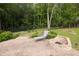 Backyard with a brick patio, lounge chair, and fire pit at 1520 Great Oaks Dr, Lawrenceville, GA 30045