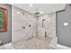 The bathroom showcases a walk-in shower with multi-spray heads, a built-in bench, and sleek gray and white tiles at 1520 Great Oaks Dr, Lawrenceville, GA 30045