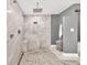 Well-lit modern bathroom features a walk-in shower with dual heads and a convenient built-in bench seat at 1520 Great Oaks Dr, Lawrenceville, GA 30045