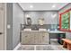 Bathroom featuring a double sink vanity, ample counter space, modern fixtures, and wood-framed windows at 1520 Great Oaks Dr, Lawrenceville, GA 30045