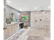 Modern bathroom with dual shower heads, pebble-style shower floor, and a vanity area for added convenience at 1520 Great Oaks Dr, Lawrenceville, GA 30045