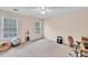 Spacious bedroom with neutral carpet, two windows, and a ceiling fan at 1520 Great Oaks Dr, Lawrenceville, GA 30045