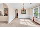 A formal dining room boasts elegant wainscoting, a chandelier, and neutral colors, perfect for gatherings at 1520 Great Oaks Dr, Lawrenceville, GA 30045