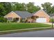 Well-maintained brick home with lush green lawn and mature landscaping for great curb appeal at 1520 Great Oaks Dr, Lawrenceville, GA 30045