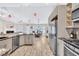 Spacious kitchen with breakfast nook area featuring stainless appliances, bar stool seating and granite counters at 1520 Great Oaks Dr, Lawrenceville, GA 30045