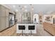 Bright kitchen boasts stainless appliances, marble counters, breakfast bar with seating and wood floors at 1520 Great Oaks Dr, Lawrenceville, GA 30045