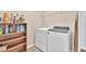 Functional laundry room features appliances, shelving and storage at 1520 Great Oaks Dr, Lawrenceville, GA 30045