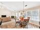 Cozy living room with breakfast nook area, large windows and wood-look flooring at 1520 Great Oaks Dr, Lawrenceville, GA 30045