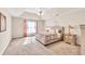 Spacious main bedroom featuring a trey ceiling, ceiling fan, plush carpet, and natural light from the window at 1520 Great Oaks Dr, Lawrenceville, GA 30045