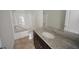 Bathroom featuring a granite countertop and tub-shower combination at 1560 Iris Walk, Jonesboro, GA 30238