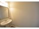 Powder room featuring a pedestal sink, mirror and simple fixtures at 1560 Iris Walk, Jonesboro, GA 30238